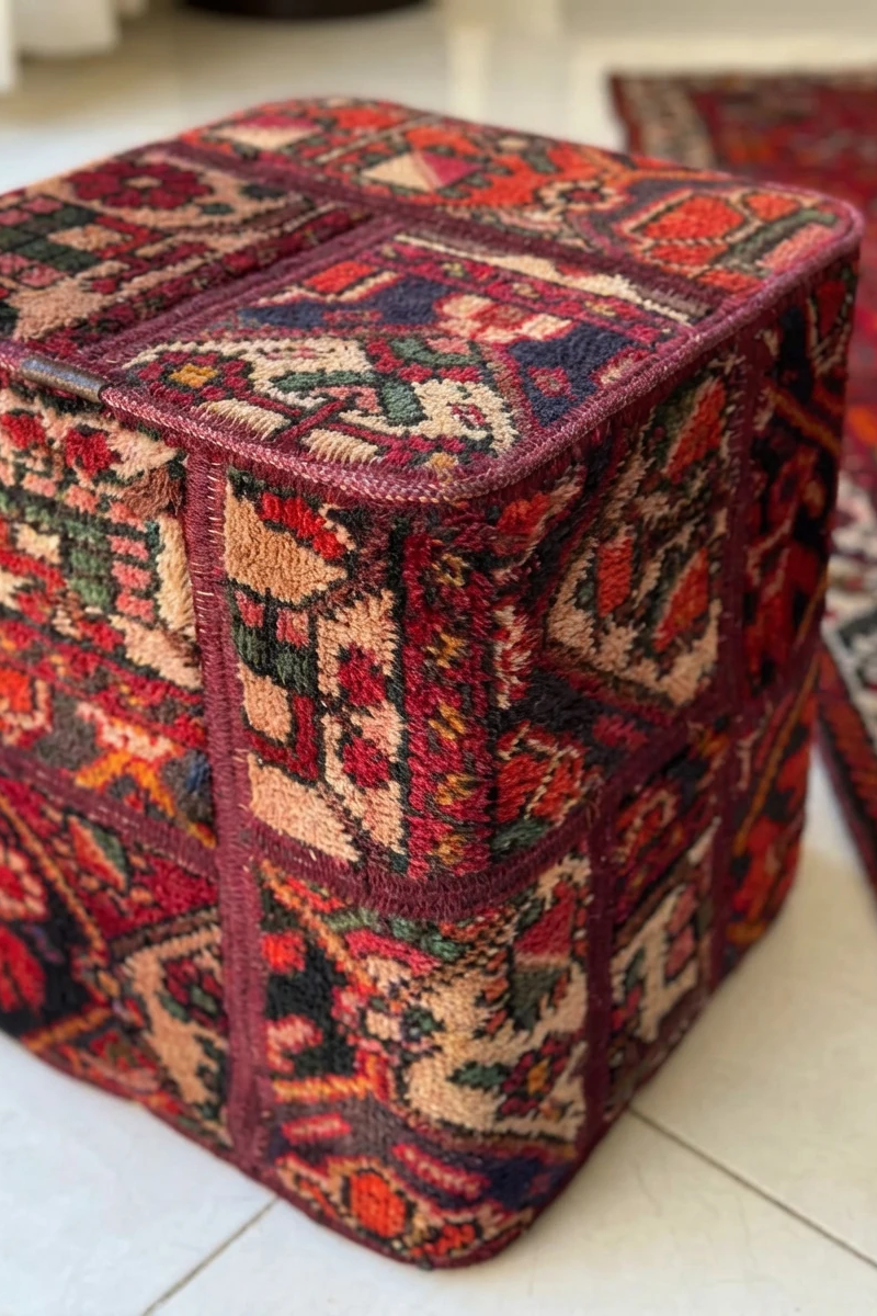 Decorative ottoman with intricate pattern on a tiled floor