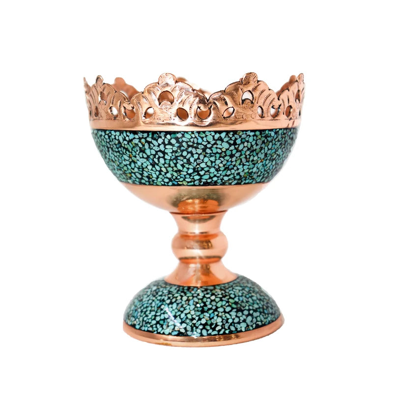Decorative candle holder with turquoise base and copper top on a white background