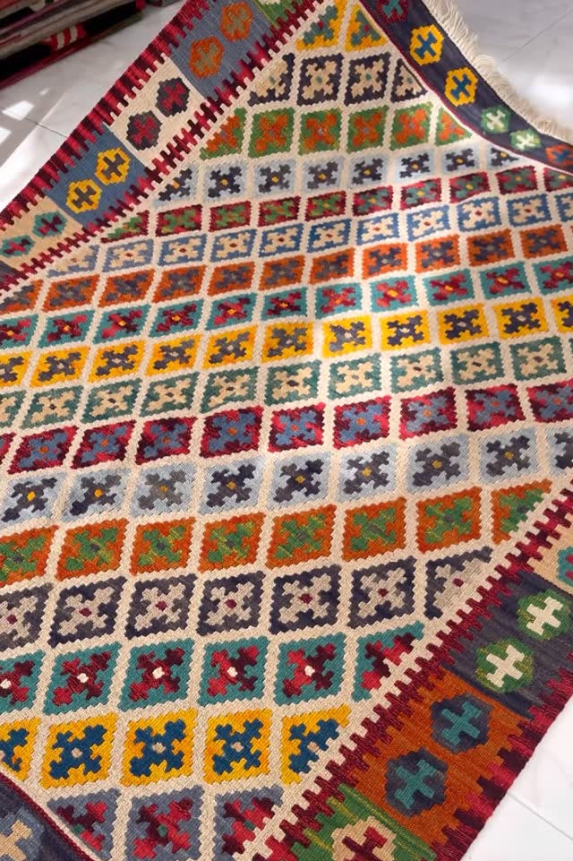 Multicolored crocheted blanket with geometric patterns