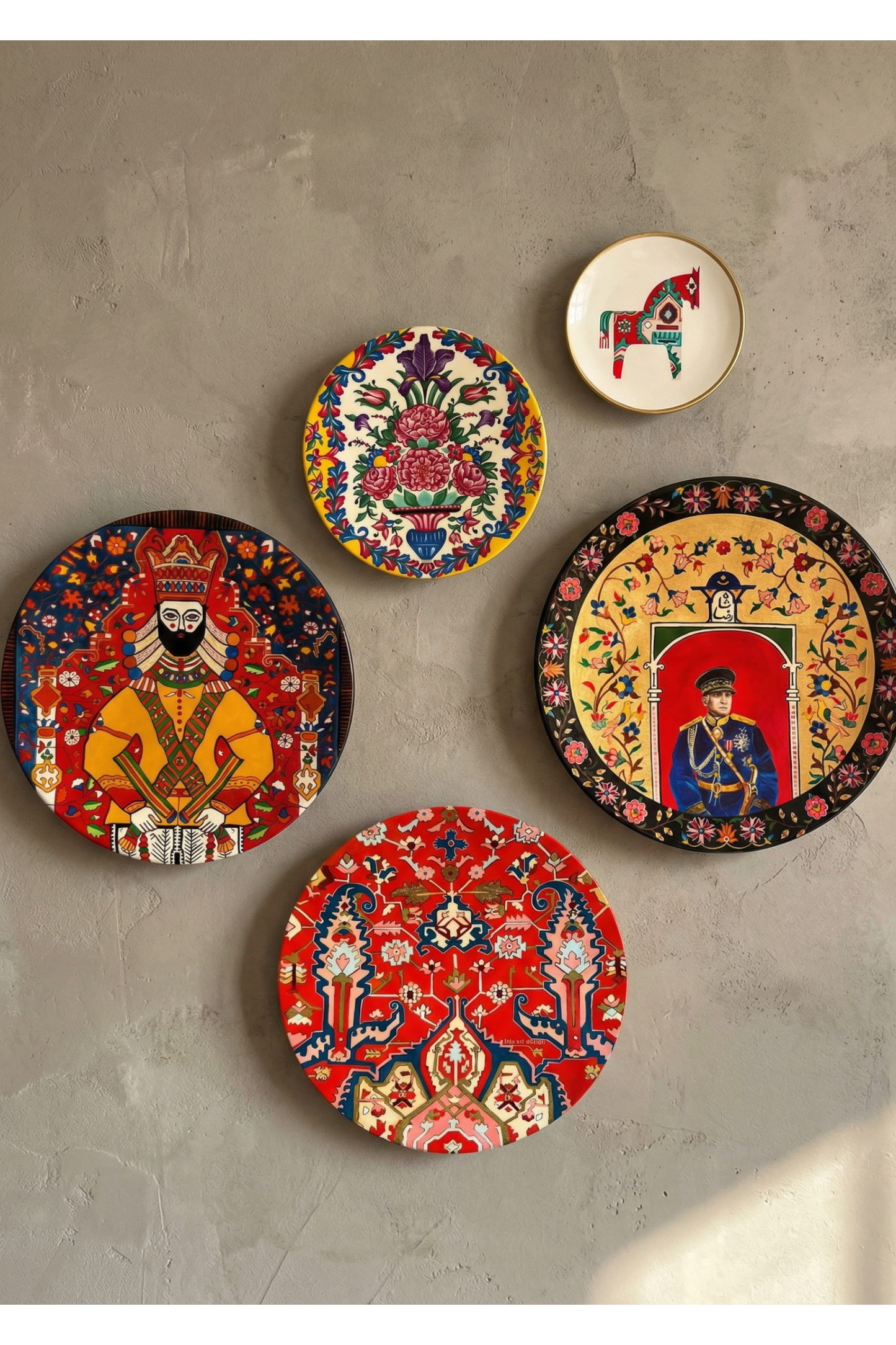 Set of decorative plates with intricate designs on a gray wall.