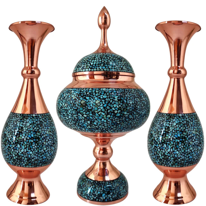 Set of three decorative vases with copper accents on a white background