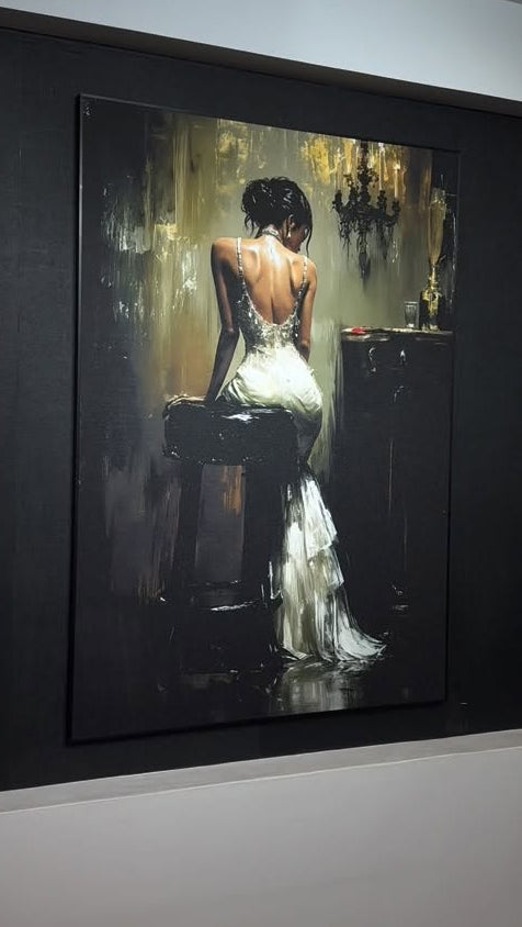 Framed painting of a woman in a white dress sitting on a stool.