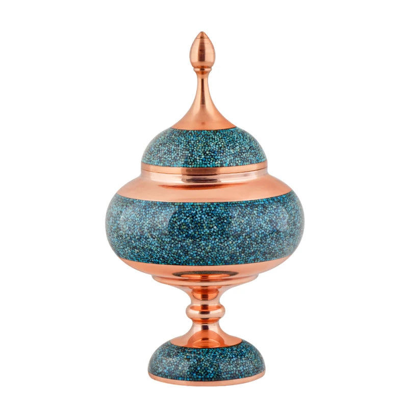 Decorative urn with blue speckled design and copper accents on a white background