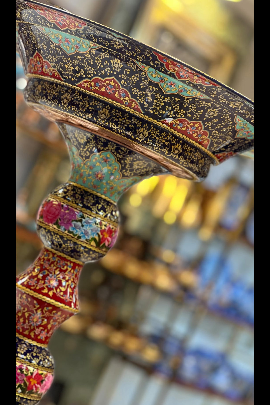 Decorative object with intricate patterns and colors, possibly a piece of jewelry or art.