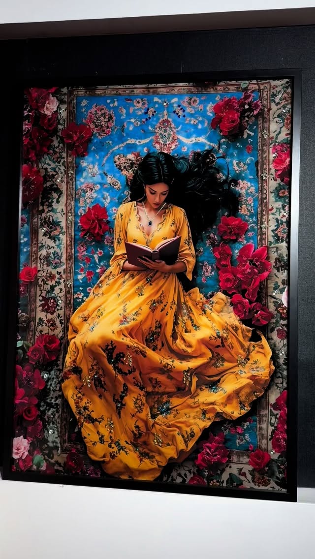 Framed artwork of a woman in a yellow dress sitting on a rug with floral patterns and red flowers.
