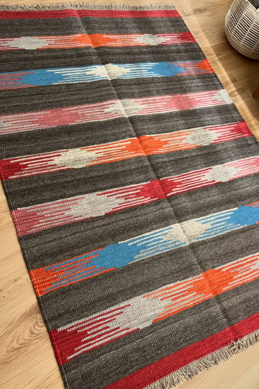 Colorful striped rug on a wooden floor