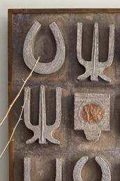 Decorative metal letters on a wooden board with a rustic finish.