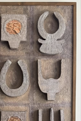 Decorative wall art with abstract stone-like shapes on a textured background
